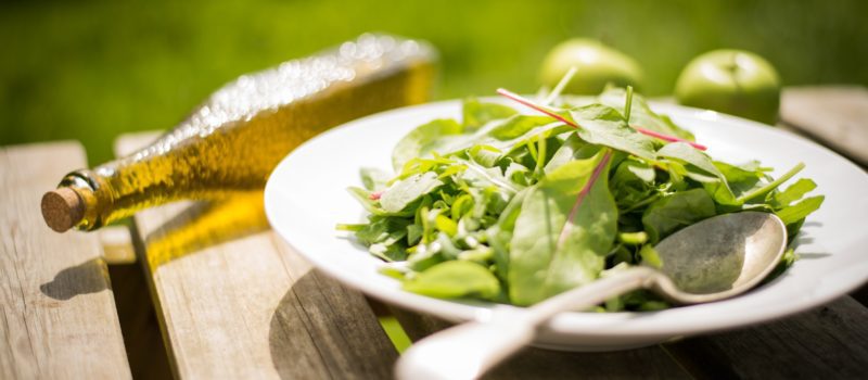 Healthy meals and fresh salad on outdoor table